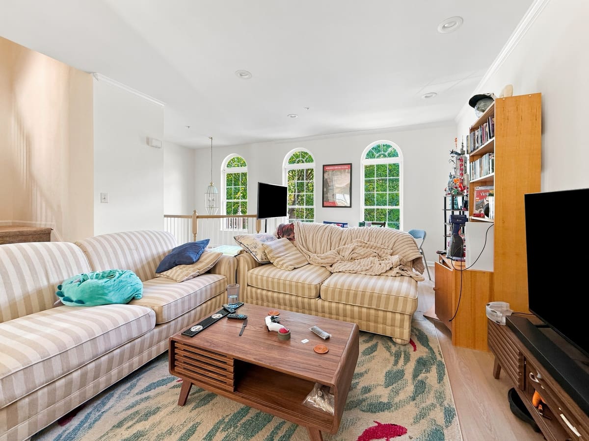 Living room with arched windows, finished with Cove Capture